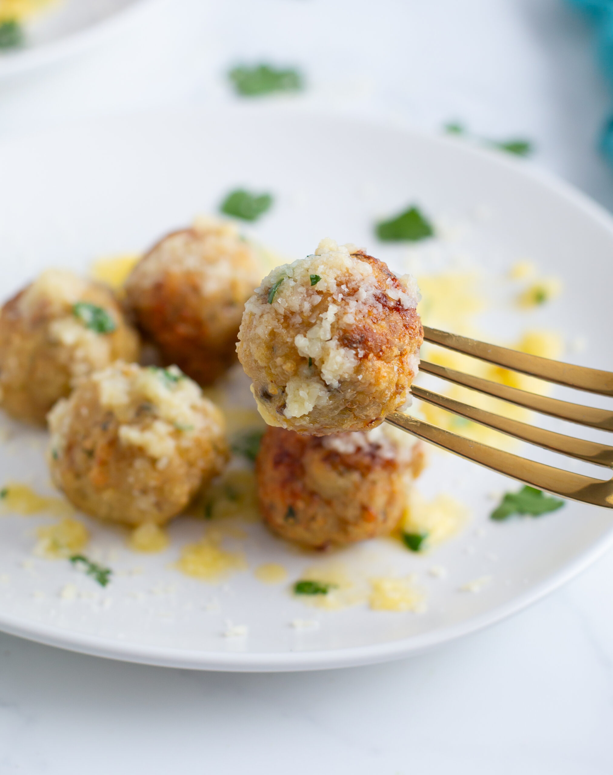 Garlic Parmesan chicken meatballs on a fork