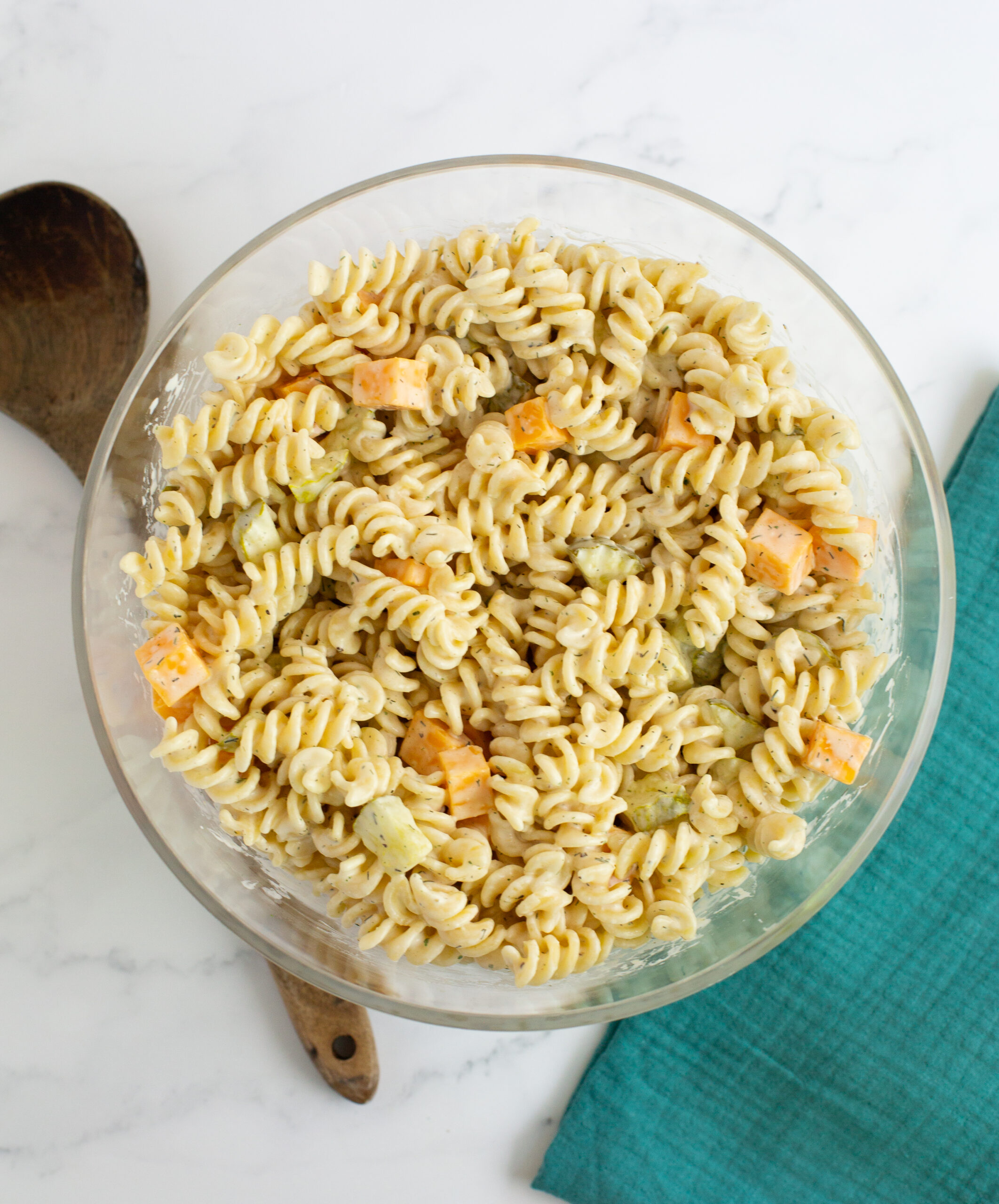 a bowl of pasta salad on a white counter