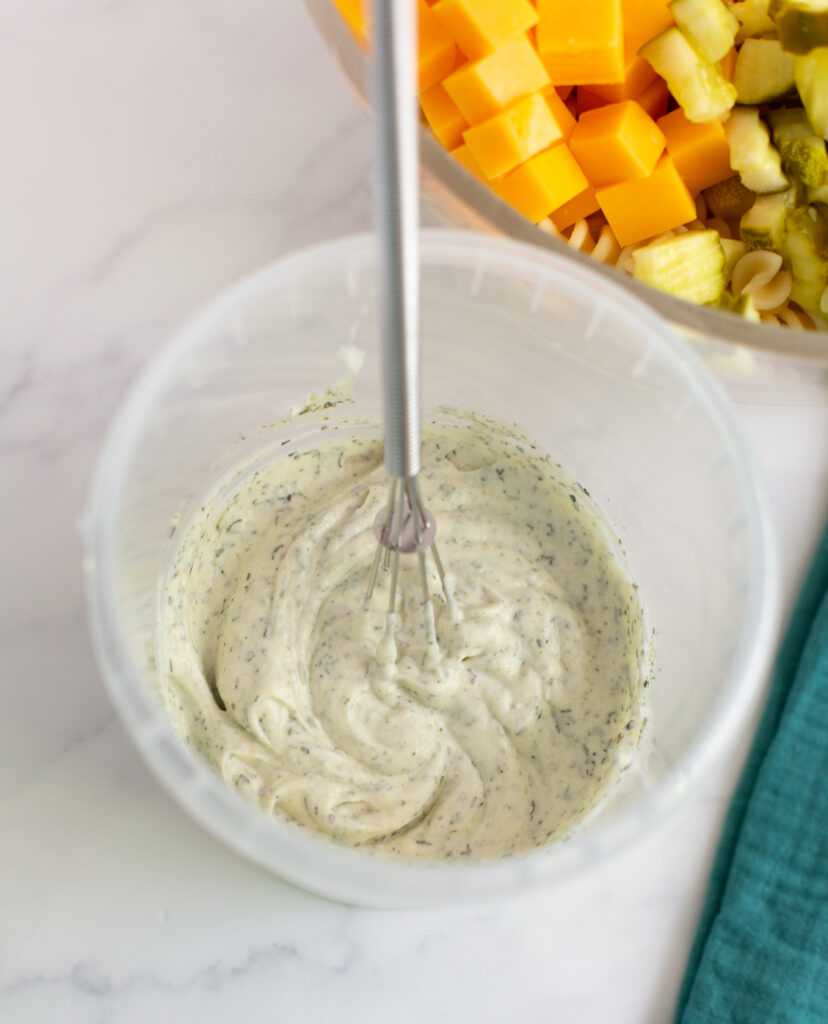 ranch dressing in a bowl with a whisk on a white counter