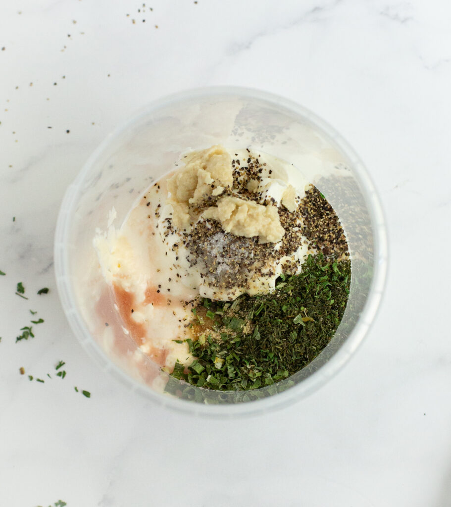 all of the ingredients for the buttermilk ranch dressing in a bowl  ready to be mixed on a white container
