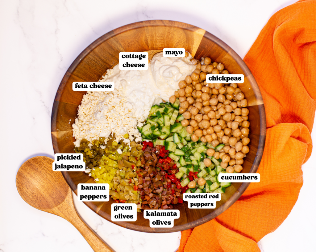 a wooden bowl on a bright white marble surface showing each ingredient