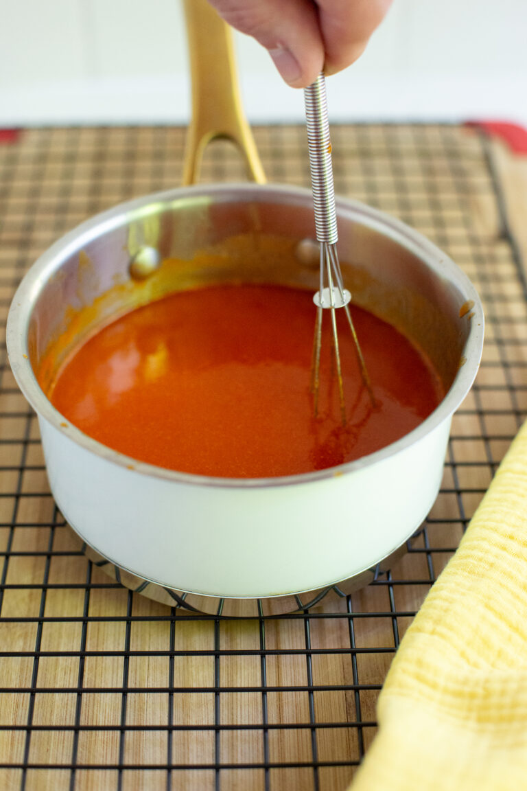 buffalo sauce in a pot on a cooling rack