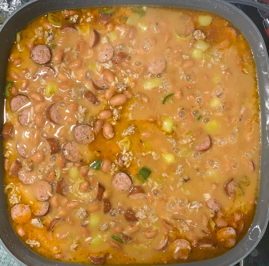 beans and meat cooking in a skillet