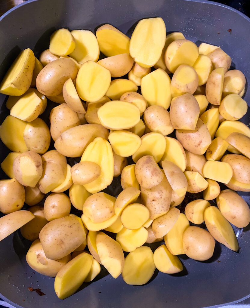 halved baby potatoes in a skillet