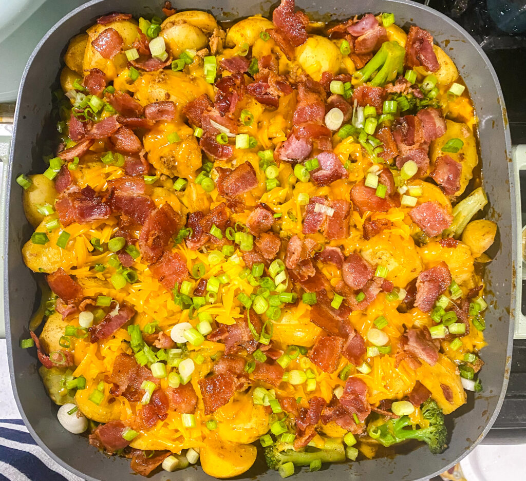 bacon, cheese, and scallions top the loaded baked potato skillet.