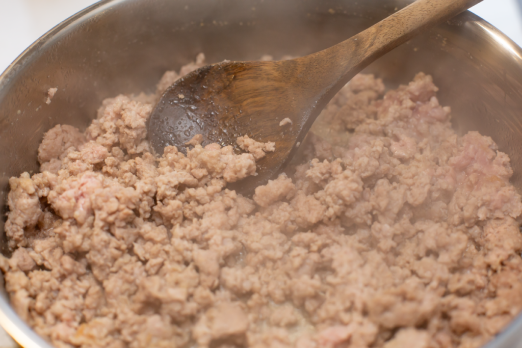 ground pork browning in a pan