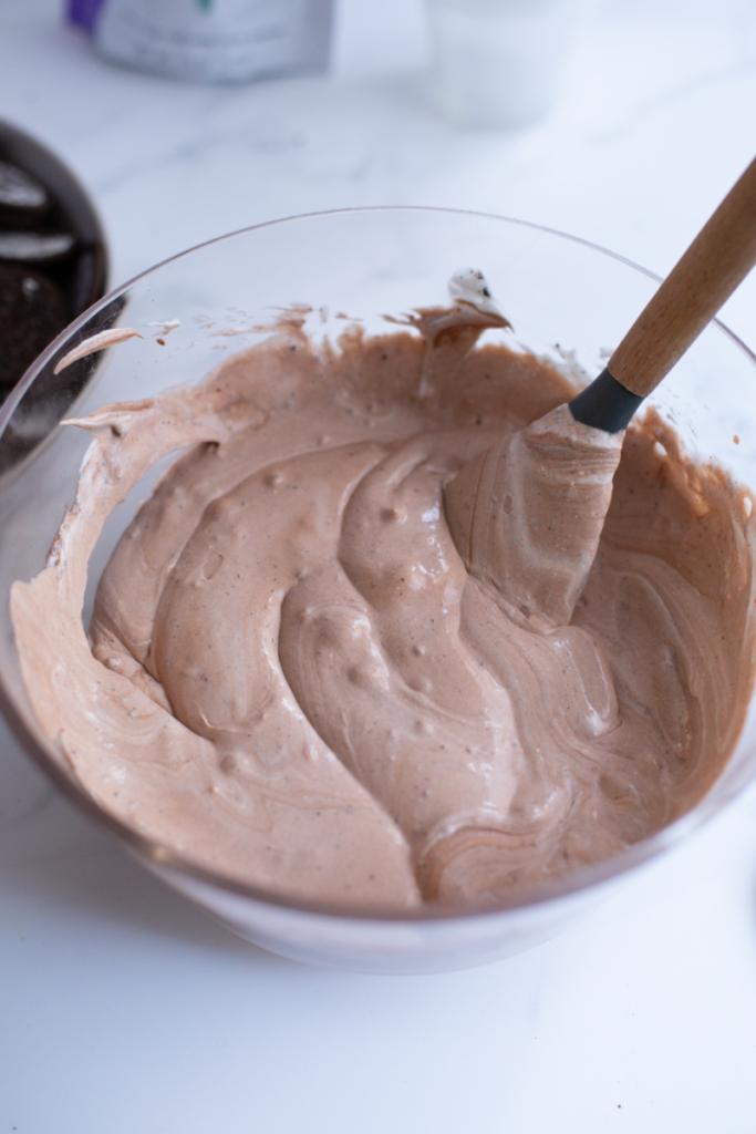 the dirt part of the pudding cups mixed together in a clear bowl