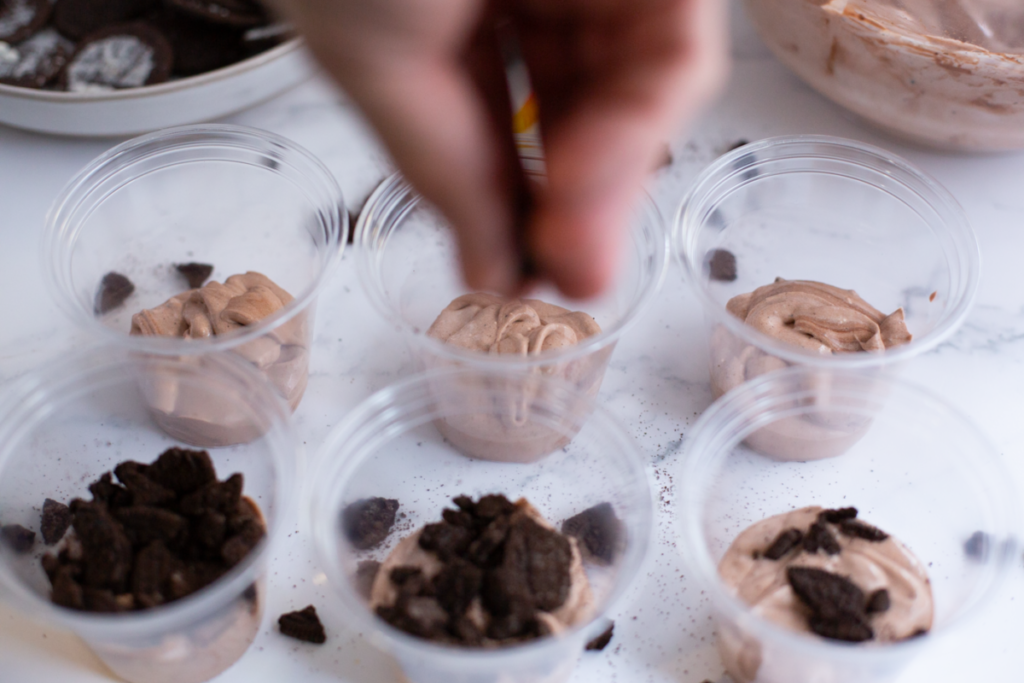 creating layers in the dirt and worms pudding cups