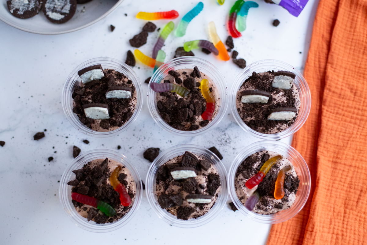 dirt and worm pudding cups placed on a bight counter