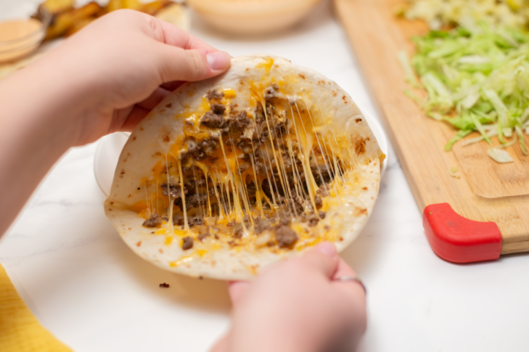 quesadilla being pulled apart showing the melty cheese