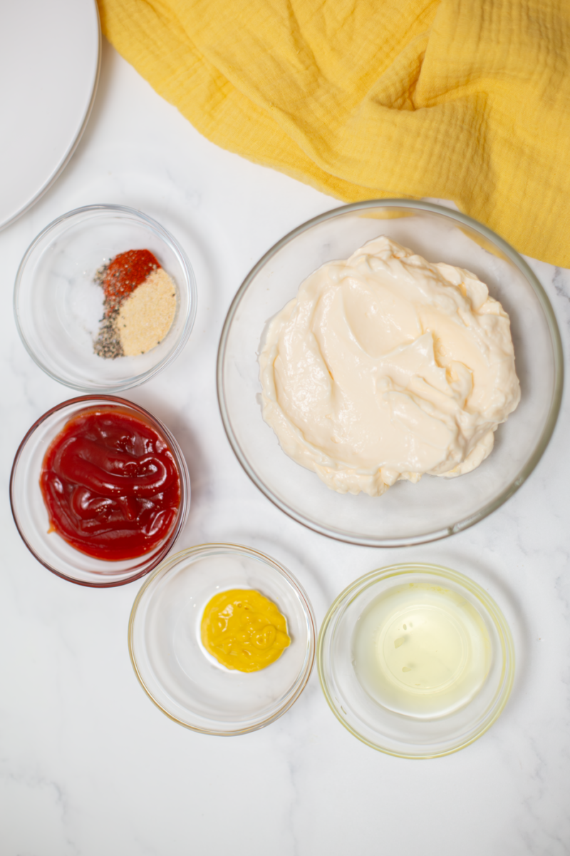 the ingredients for the burger sauce in clear bowls