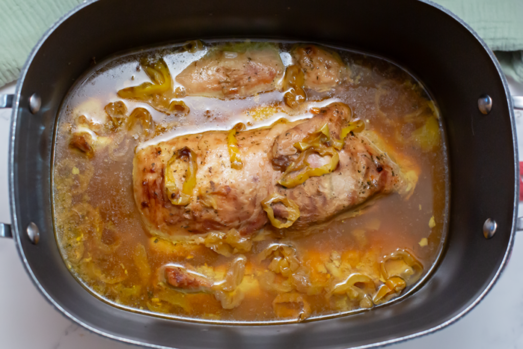 mississippi pork roast in a slow cooker on a white counter completely cooked