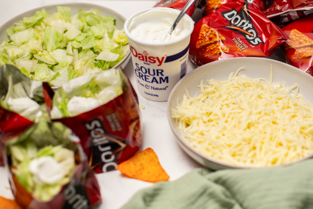 toppings for walking tacos on a white counter