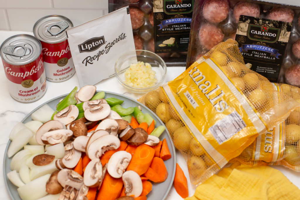 ingredients for slow cooker meatball stew on a white counter